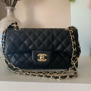 Black designer handbag with gold hardware.